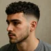 a man with curly french crop haircut