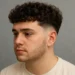 a man with french crop perm
